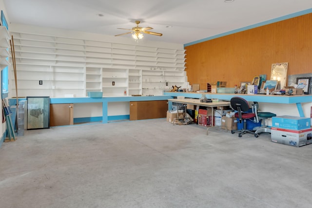 interior space featuring wood walls and ceiling fan