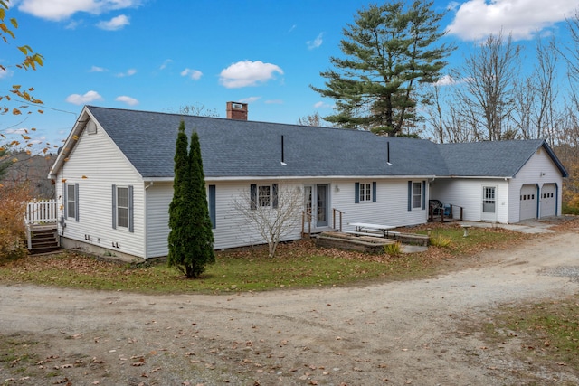 back of house featuring a garage