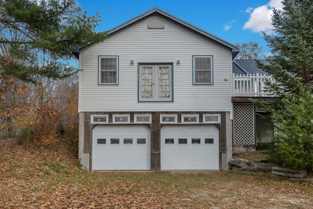 exterior space featuring a wooden deck and a garage