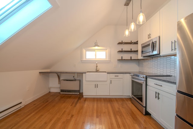 kitchen featuring stainless steel appliances, tasteful backsplash, baseboard heating, white cabinets, and sink