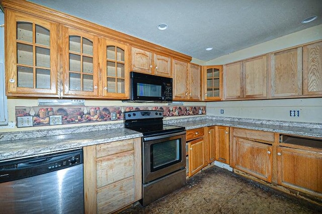 kitchen featuring stainless steel appliances and light stone counters