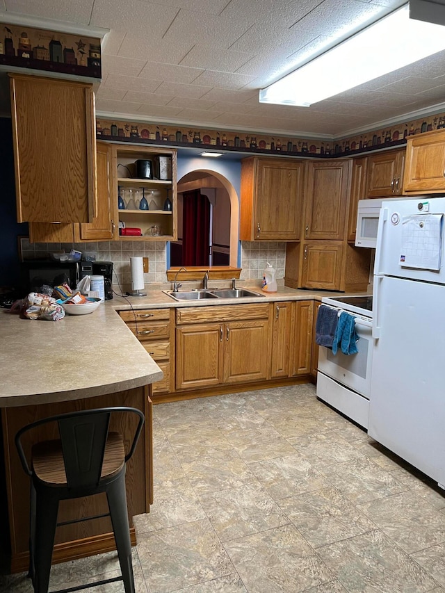 752 Caribou Rd, Fort Kent, ME 04743 - kitchen featuring a textured ceiling, decorative backsplash, sink, and white appliances