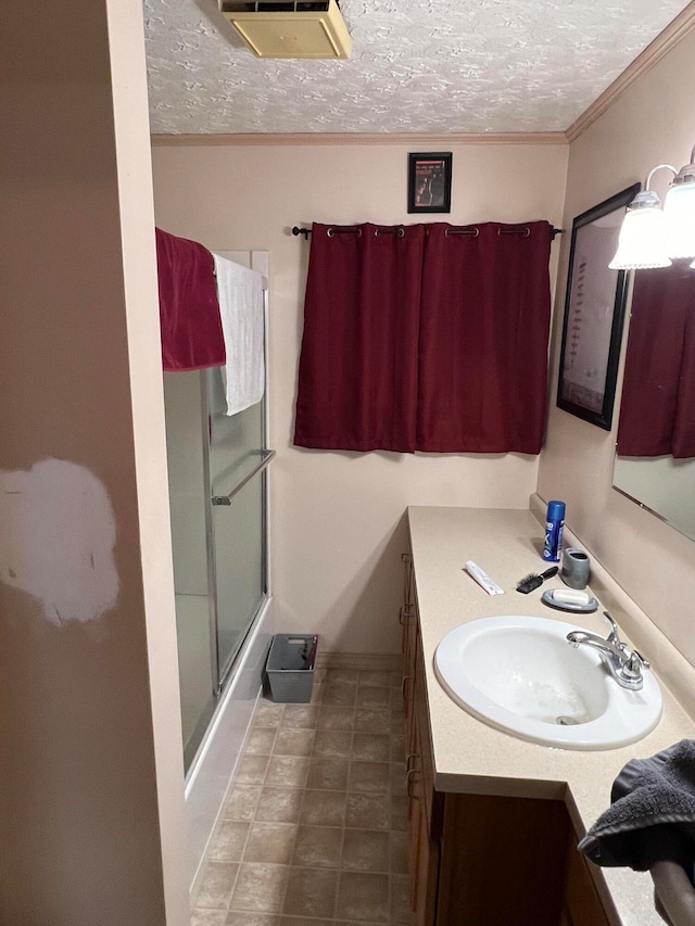 752 Caribou Rd, Fort Kent, ME 04743 - bathroom featuring vanity, crown molding, a textured ceiling, and combined bath / shower with glass door