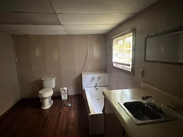 452 Station Rd, Easton, ME 04740 - bathroom featuring a tub, toilet, wood-type flooring, sink, and a paneled ceiling