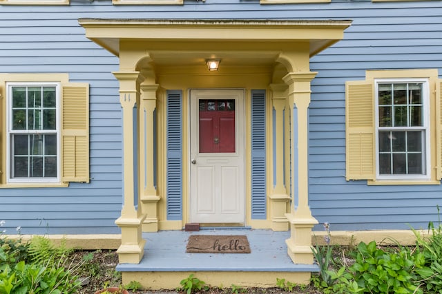 view of exterior entry with covered porch