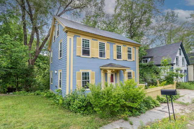 colonial-style house with a front lawn