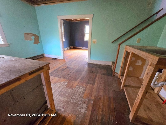 corridor with hardwood / wood-style flooring