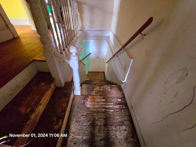 staircase with hardwood / wood-style flooring