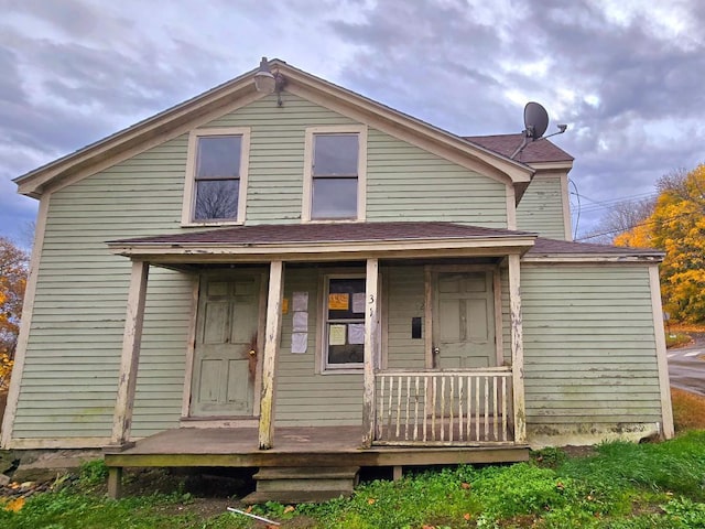 rear view of house featuring covered porch