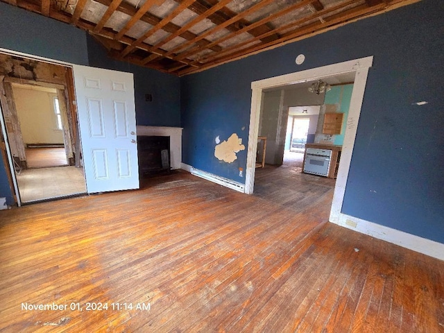 unfurnished living room with vaulted ceiling and hardwood / wood-style flooring