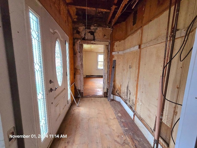 corridor with hardwood / wood-style flooring