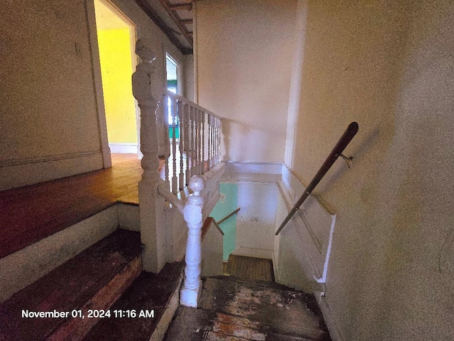 stairs featuring hardwood / wood-style flooring