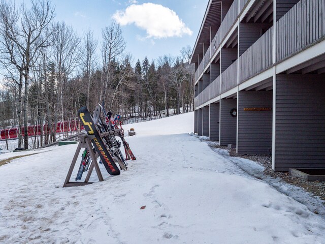 snowy yard featuring a playground