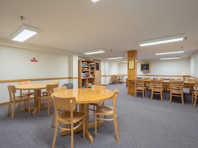 dining area featuring dark colored carpet