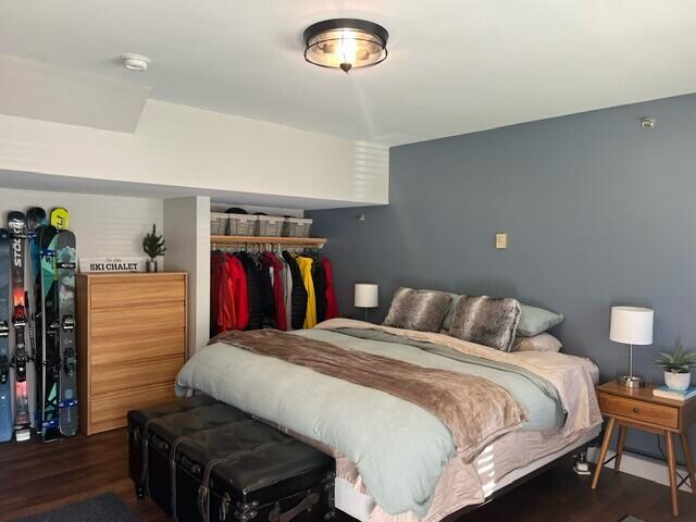 bedroom featuring a closet and dark hardwood / wood-style floors