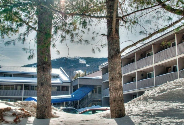 snow covered property featuring a mountain view