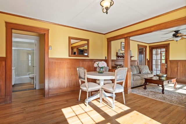 dining room featuring hardwood / wood-style floors, ceiling fan, and crown molding