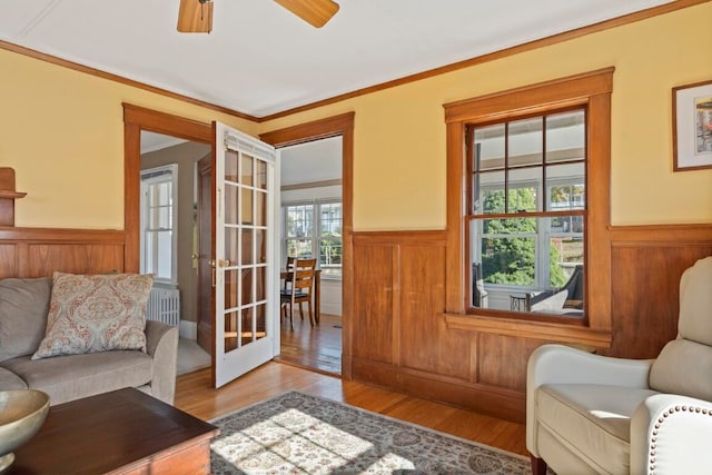 sitting room featuring ornamental molding, plenty of natural light, light hardwood / wood-style floors, and ceiling fan