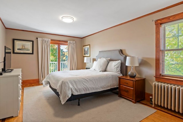 bedroom featuring access to exterior, light wood-type flooring, radiator heating unit, and crown molding