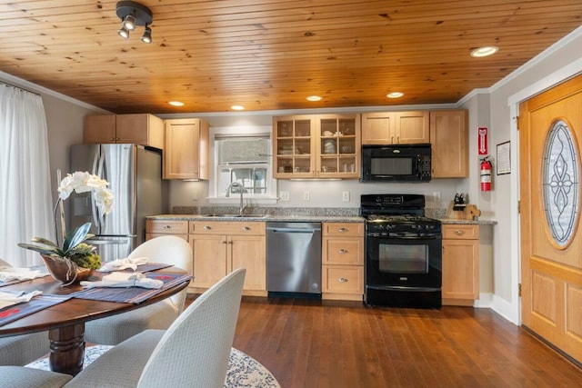 kitchen featuring light stone counters, black appliances, sink, ornamental molding, and dark hardwood / wood-style floors