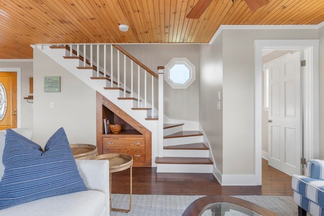 stairs featuring wooden ceiling, hardwood / wood-style flooring, and ornamental molding