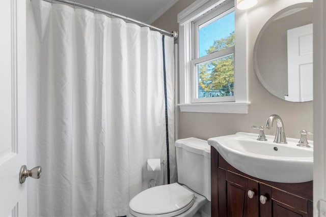 bathroom with crown molding, walk in shower, vanity, and toilet