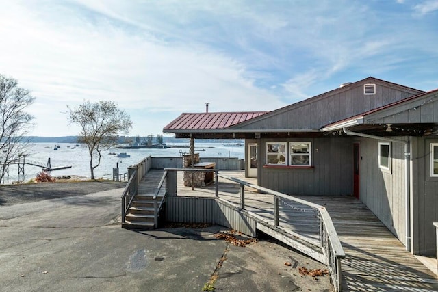 exterior space with a deck with water view