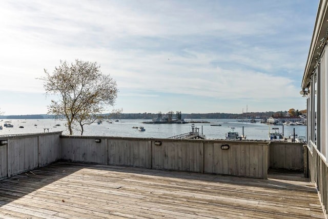 wooden deck featuring a water view