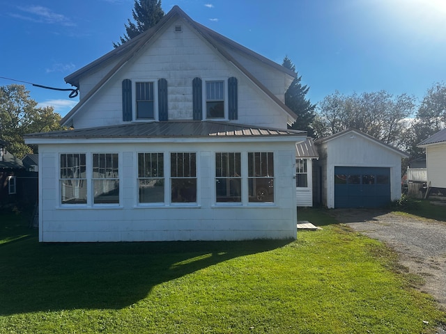 view of property exterior with an outdoor structure, a garage, and a lawn