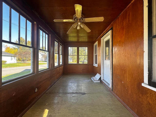 unfurnished sunroom with ceiling fan and wooden ceiling