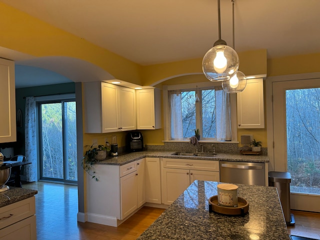 kitchen with dishwasher, light hardwood / wood-style flooring, hanging light fixtures, sink, and white cabinetry