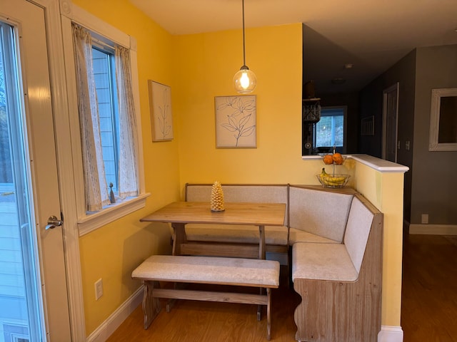 dining room featuring breakfast area and wood-type flooring