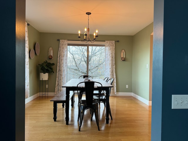 dining area with a chandelier and light wood-type flooring