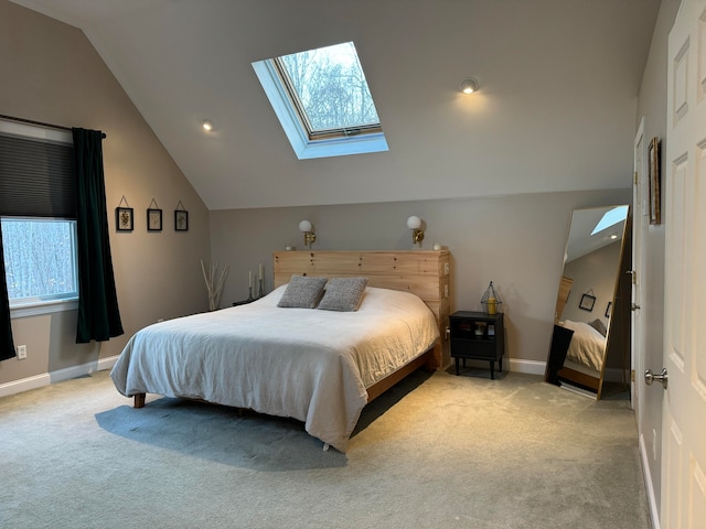 carpeted bedroom with lofted ceiling with skylight