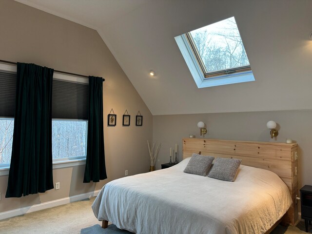 bedroom featuring light carpet and lofted ceiling with skylight