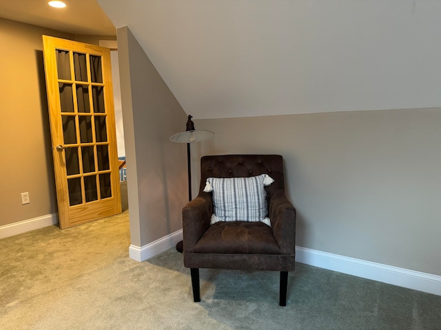 living area with light carpet and lofted ceiling