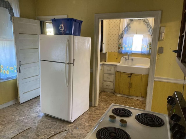 kitchen with sink and white appliances