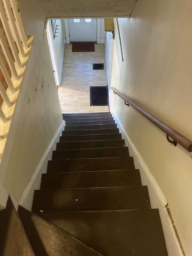 staircase featuring hardwood / wood-style flooring