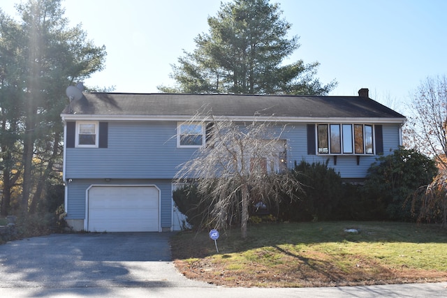 view of front facade with a garage and a front lawn