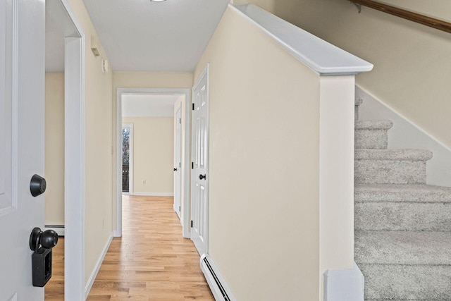 interior space with light hardwood / wood-style floors and baseboard heating