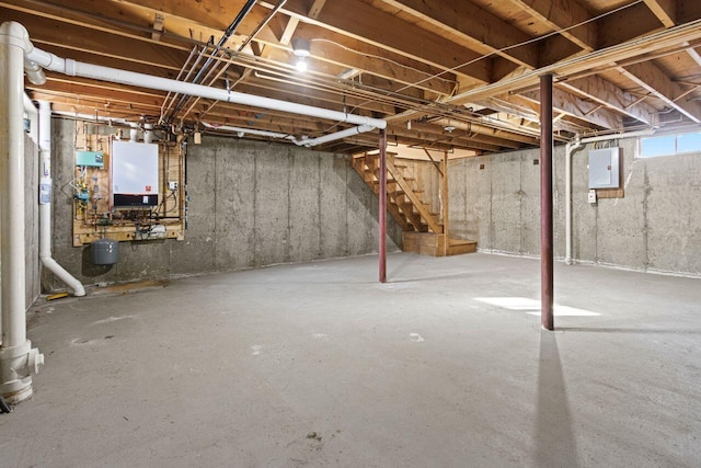 basement with electric panel and tankless water heater