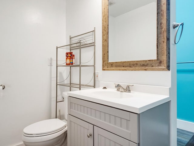 bathroom featuring vanity and toilet