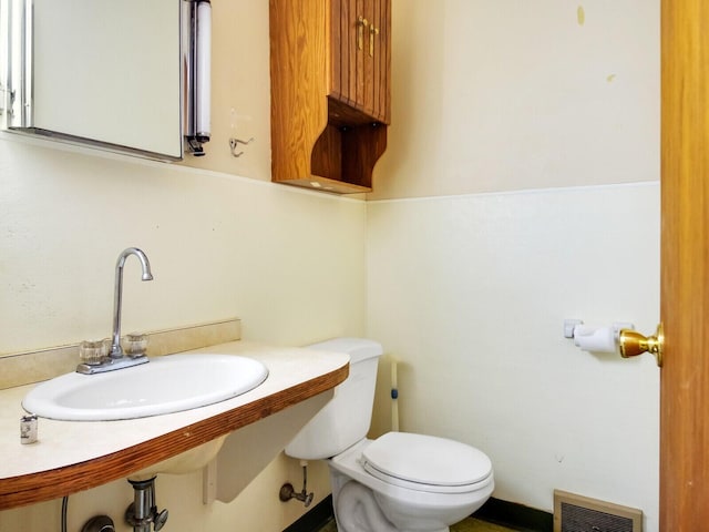 bathroom with toilet and sink