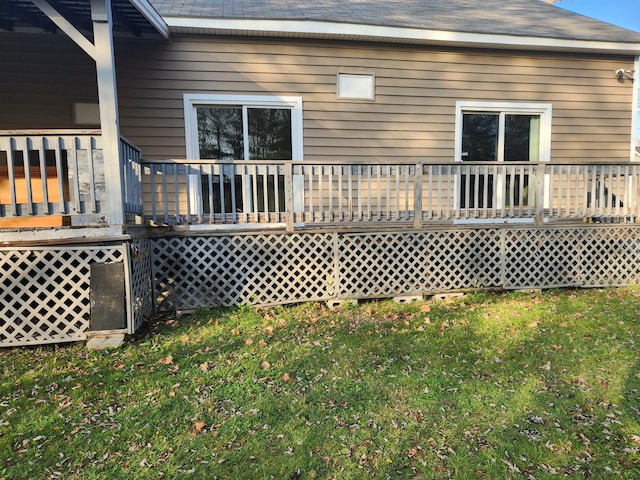 back of house featuring a yard and a deck