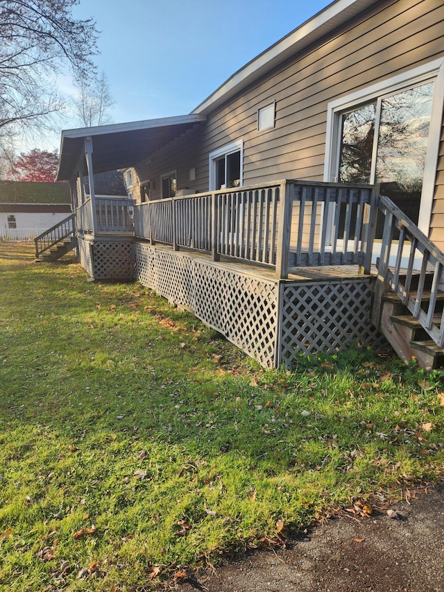 exterior space with a wooden deck and a yard