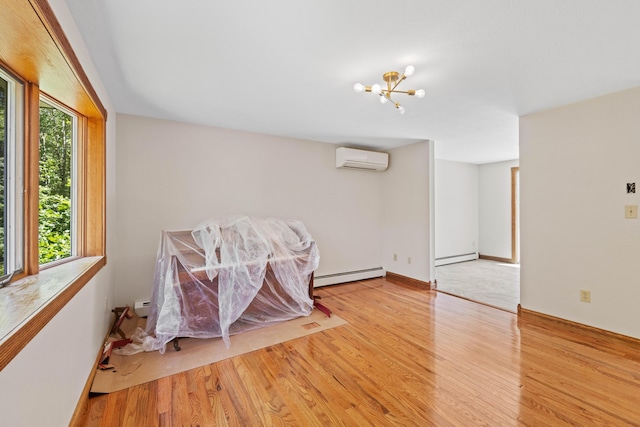221 Frost Rd, Lyman, ME 04002 - unfurnished room featuring a wall mounted AC, a baseboard heating unit, and wood finished floors