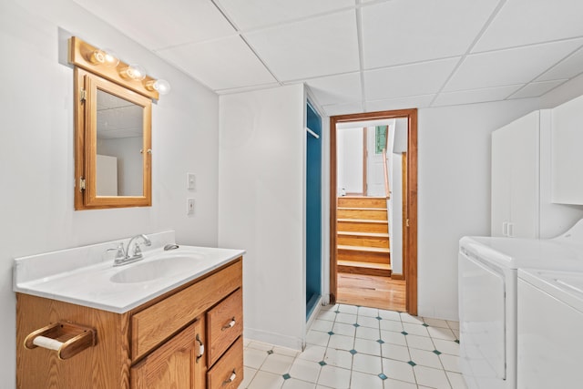 221 Frost Rd, Lyman, ME 04002 - bathroom with independent washer and dryer, vanity, a drop ceiling, and tile patterned floors