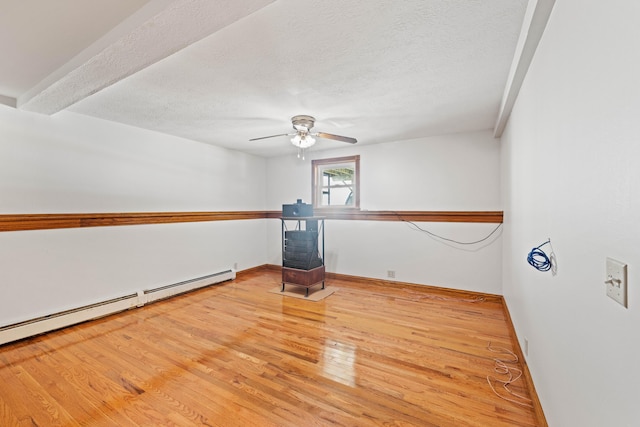 221 Frost Rd, Lyman, ME 04002 - empty room with wood finished floors, a ceiling fan, a baseboard radiator, and a textured ceiling