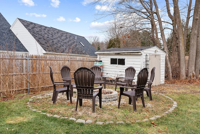 view of yard with an outdoor fire pit and a storage shed