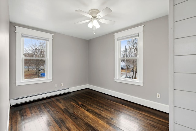 unfurnished room featuring dark hardwood / wood-style flooring, a healthy amount of sunlight, and a baseboard radiator